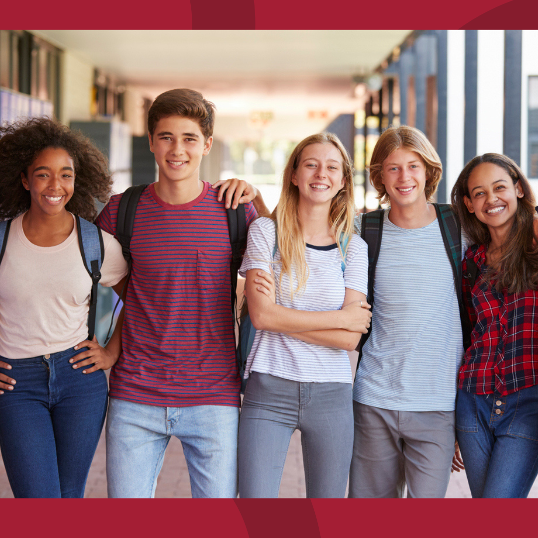 A group of teens smiling.